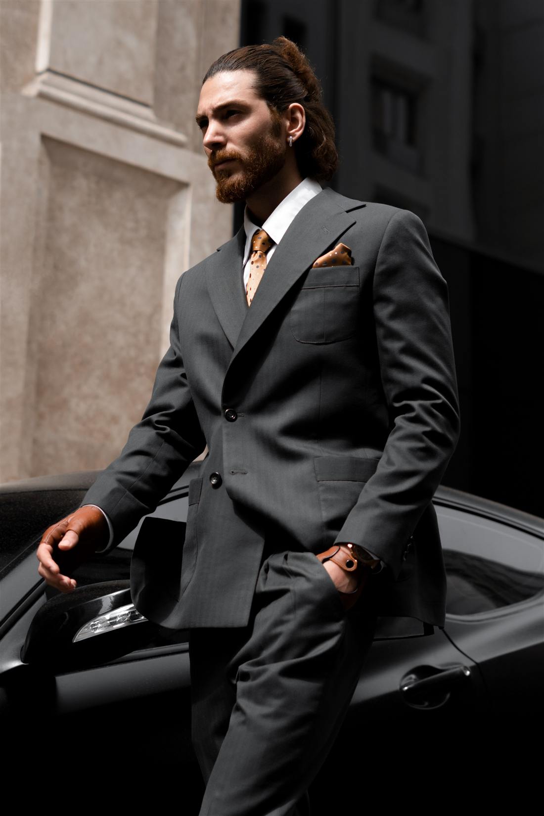 A luxury automotive specialist beside a client vehicle