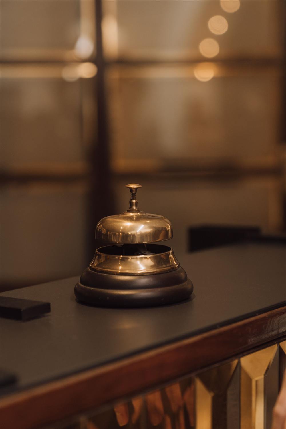 A concierge bell on a hotel front desk